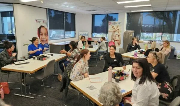 An image of educators sitting at desks talking and planning